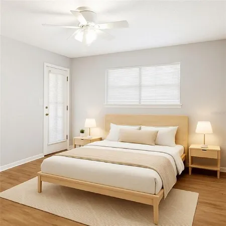 a bedroom with a bed and a ceiling fan