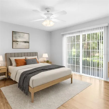 a bedroom with bed and a large window