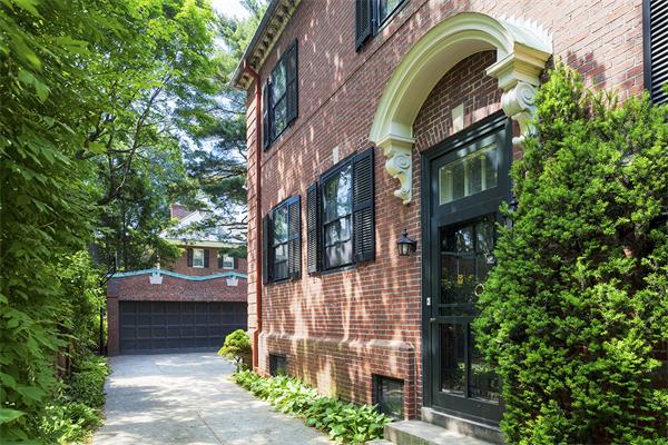 22 Worthington Road Brookline, MA 02446 - Photo 7 of 8 a view of a brick house with plants and large trees
