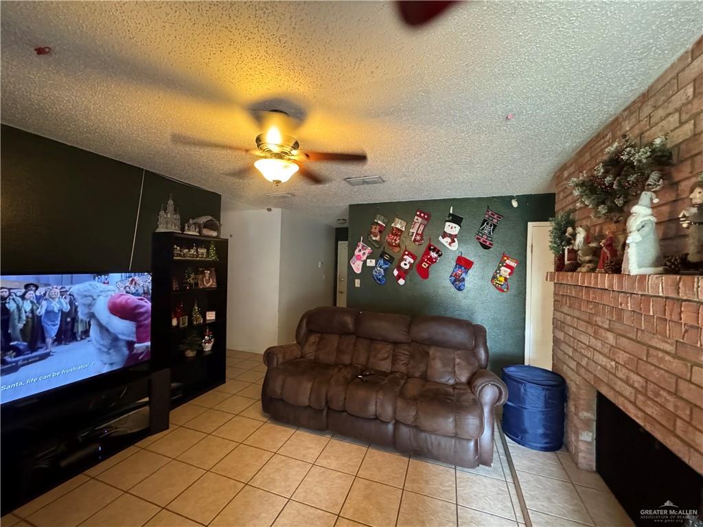 2018 West Adrian Street Harlingen, TX 78552 - Photo 6 of 13 a living room with furniture and a fireplace