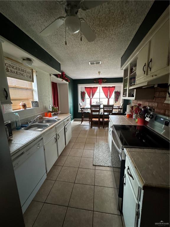 2018 West Adrian Street Harlingen, TX 78552 - Photo 9 of 13 a kitchen with stainless steel appliances granite countertop a sink and cabinets