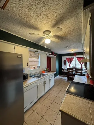 a kitchen with stainless steel appliances granite countertop a sink and a stove