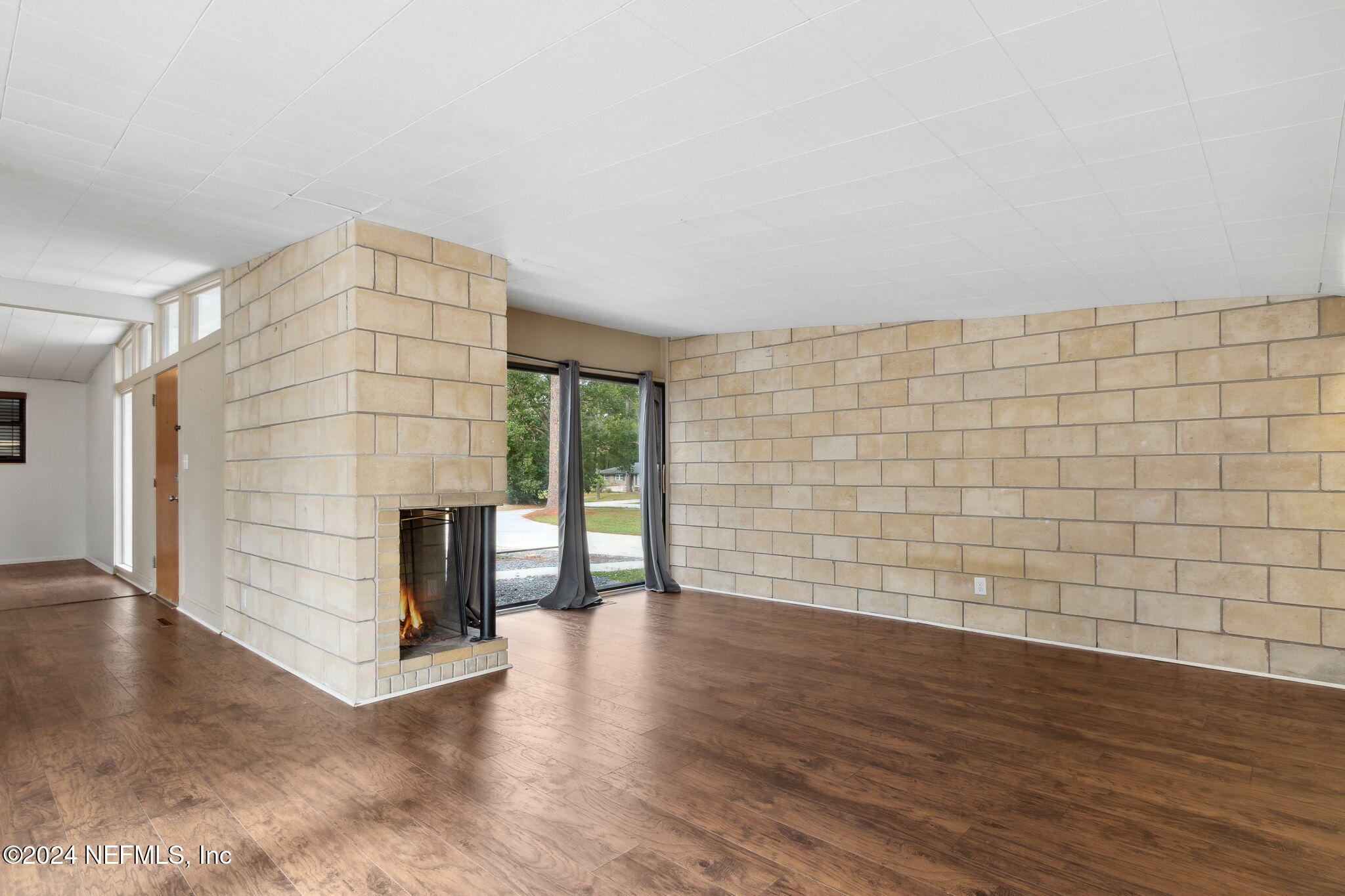 2770 Scott Circle Jacksonville, FL 32223 - Photo 12 of 33 a view of empty room with wooden floor and fireplace