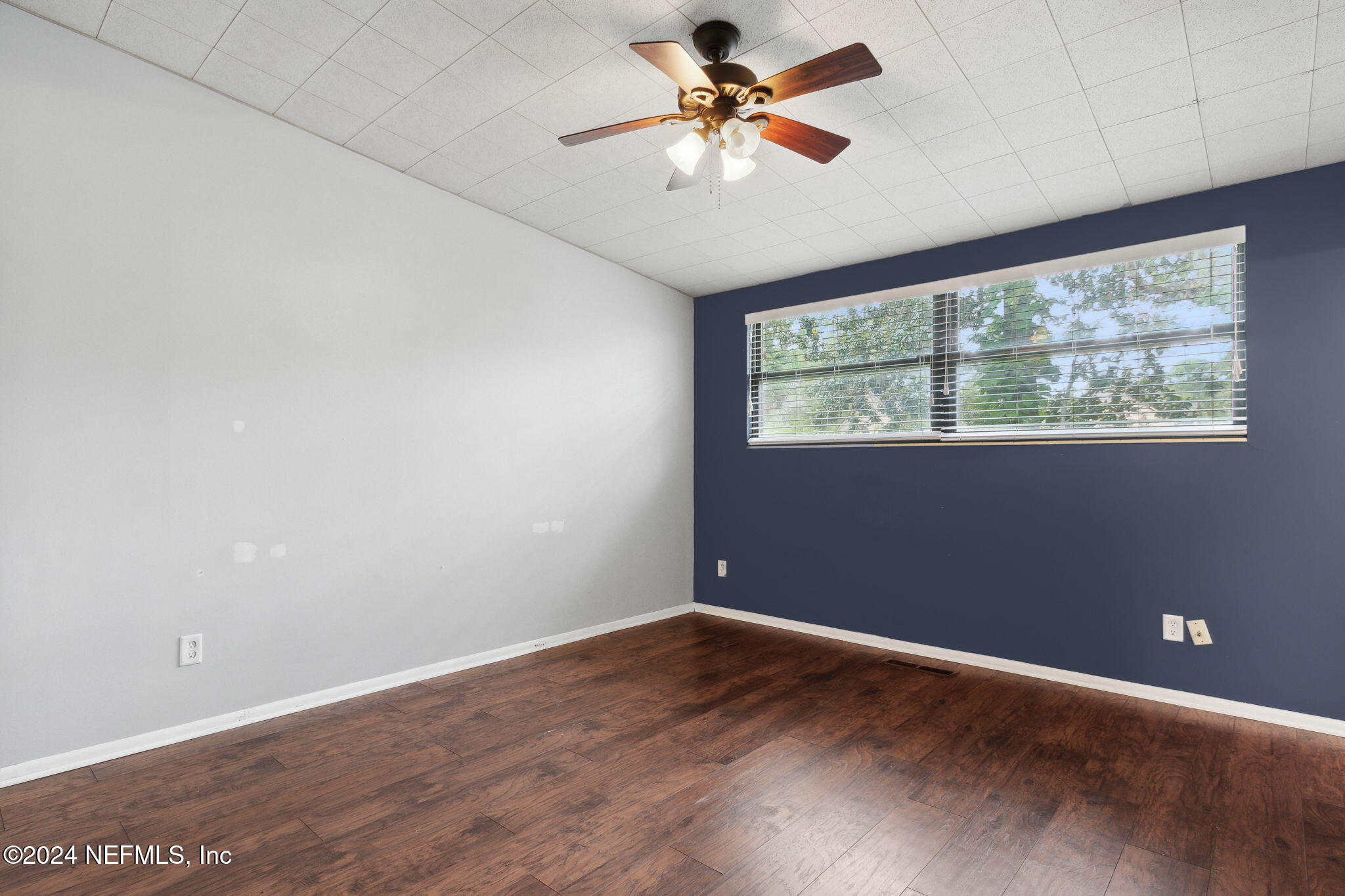 2770 Scott Circle Jacksonville, FL 32223 - Photo 20 of 33 an empty room with wooden floor and windows