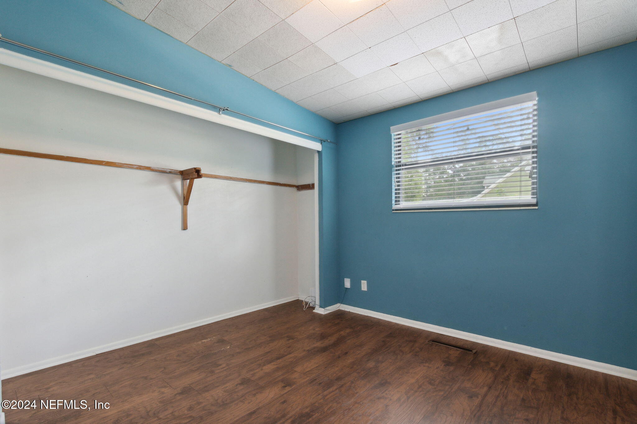 2770 Scott Circle Jacksonville, FL 32223 - Photo 23 of 33 a view of an empty room with wooden floor and a window