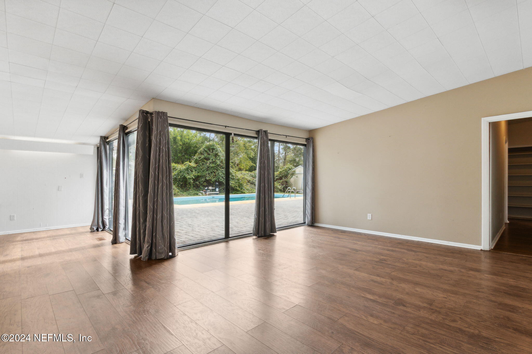 2770 Scott Circle Jacksonville, FL 32223 - Photo 10 of 33 wooden floor in an empty room with a window