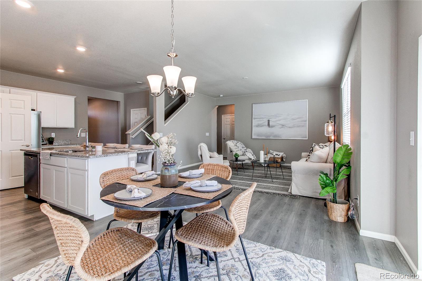 10099 Cascade Street Firestone, CO 80504 - Photo 12 of 46 a view of a dining room with furniture and wooden floor