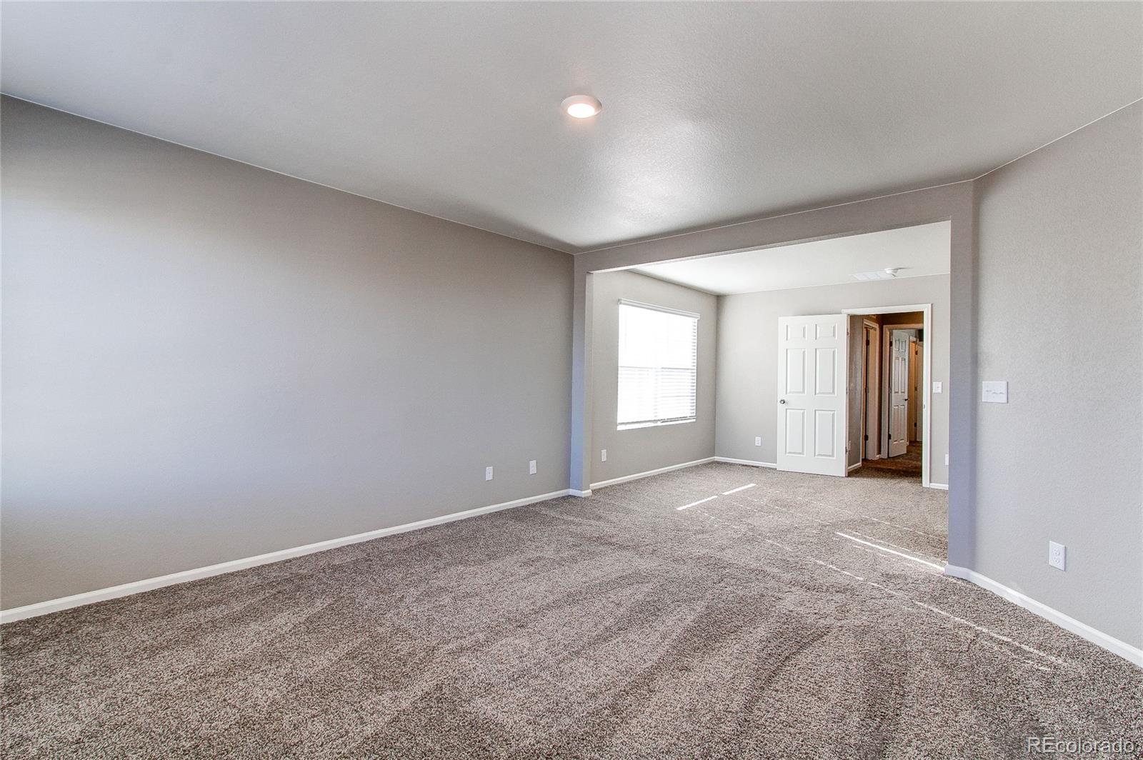 10099 Cascade Street Firestone, CO 80504 - Photo 17 of 46 a view of an empty room with closet and bathroom