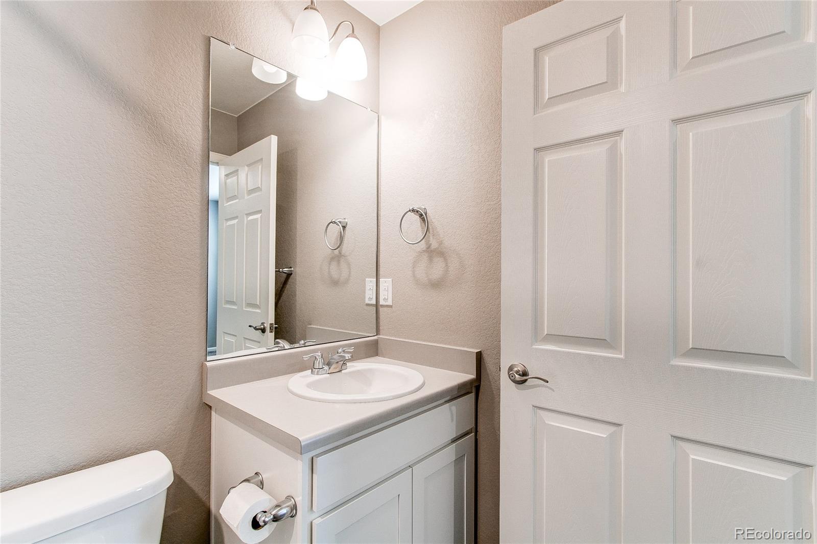 10099 Cascade Street Firestone, CO 80504 - Photo 27 of 46 a bathroom with a sink vanity and a mirror