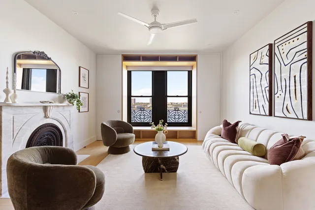 a living room with furniture fireplace and window