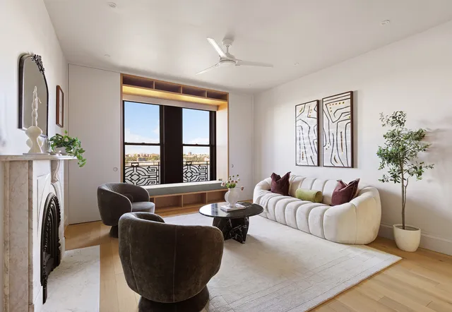 a living room with furniture potted plant and a window