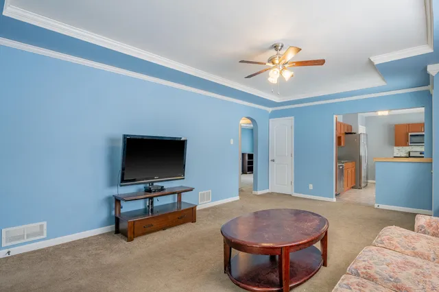 a living room with furniture and a flat screen tv