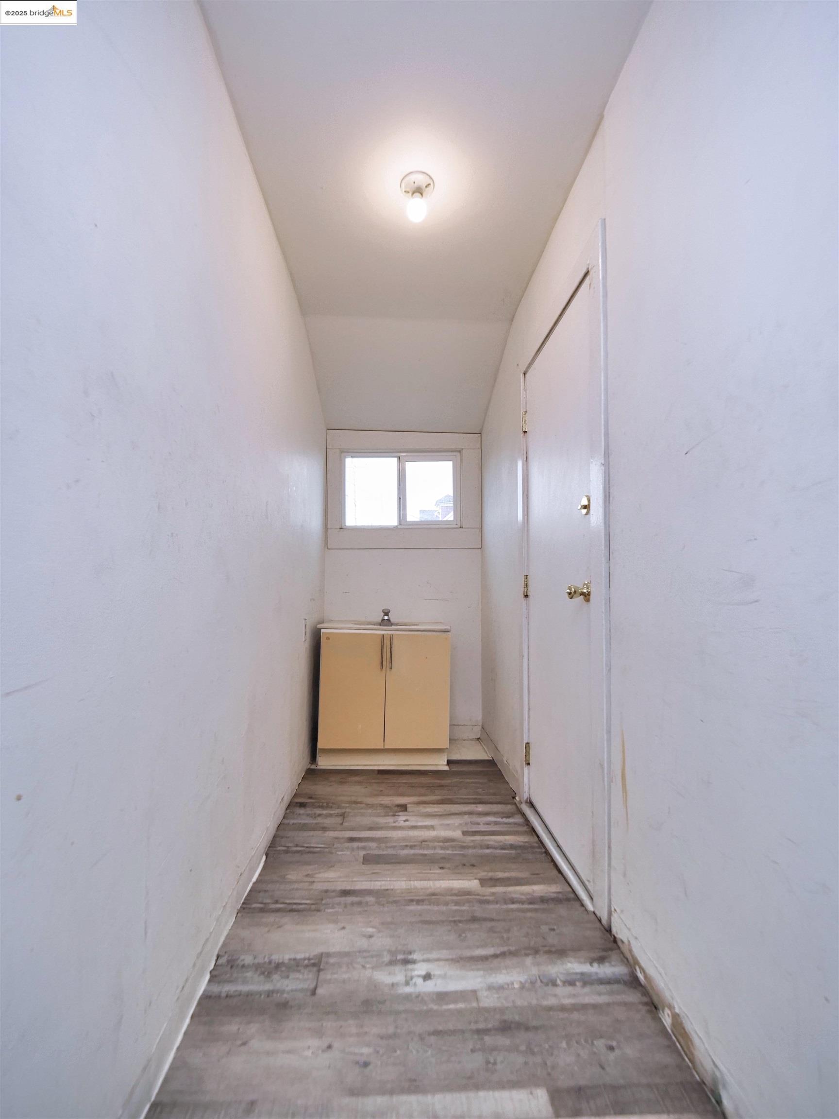 2103 Myrtle Street Oakland, CA 94607 - Photo 16 of 21 a view of a room with wooden floor and windows