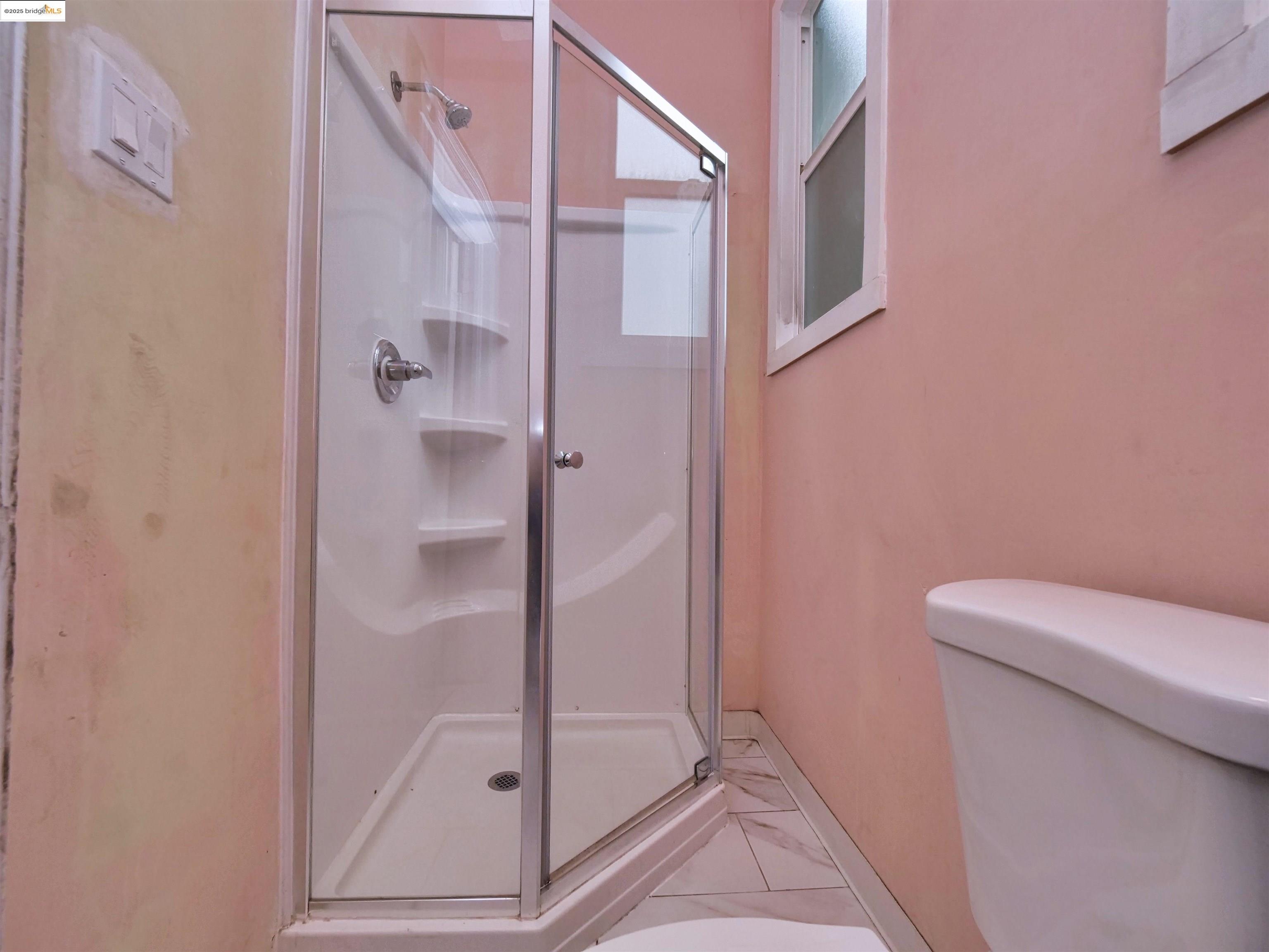 2103 Myrtle Street Oakland, CA 94607 - Photo 17 of 21 a bathroom with a shower and toilet