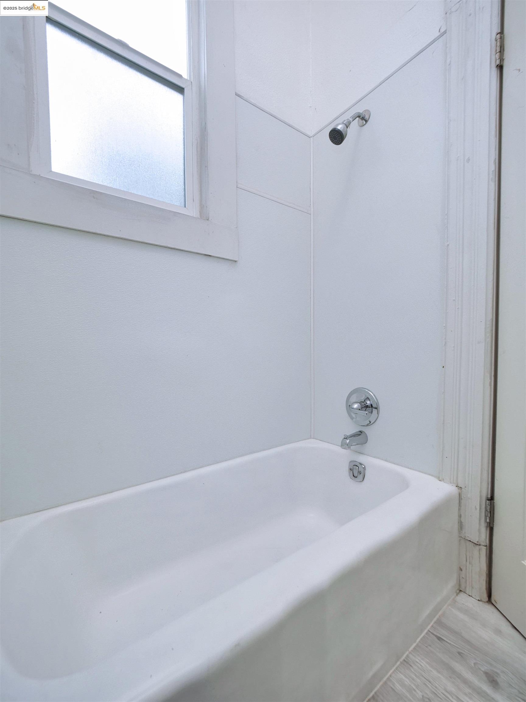2103 Myrtle Street Oakland, CA 94607 - Photo 19 of 21 a white bath tub sitting next to a window