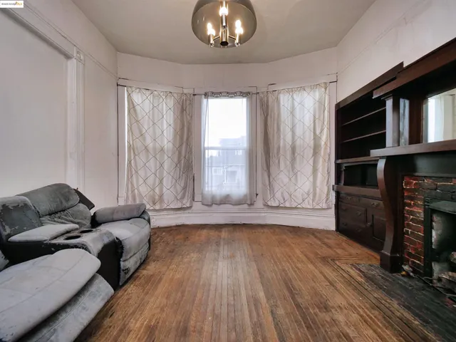 a view of livingroom with furniture wooden floor fireplace and a window