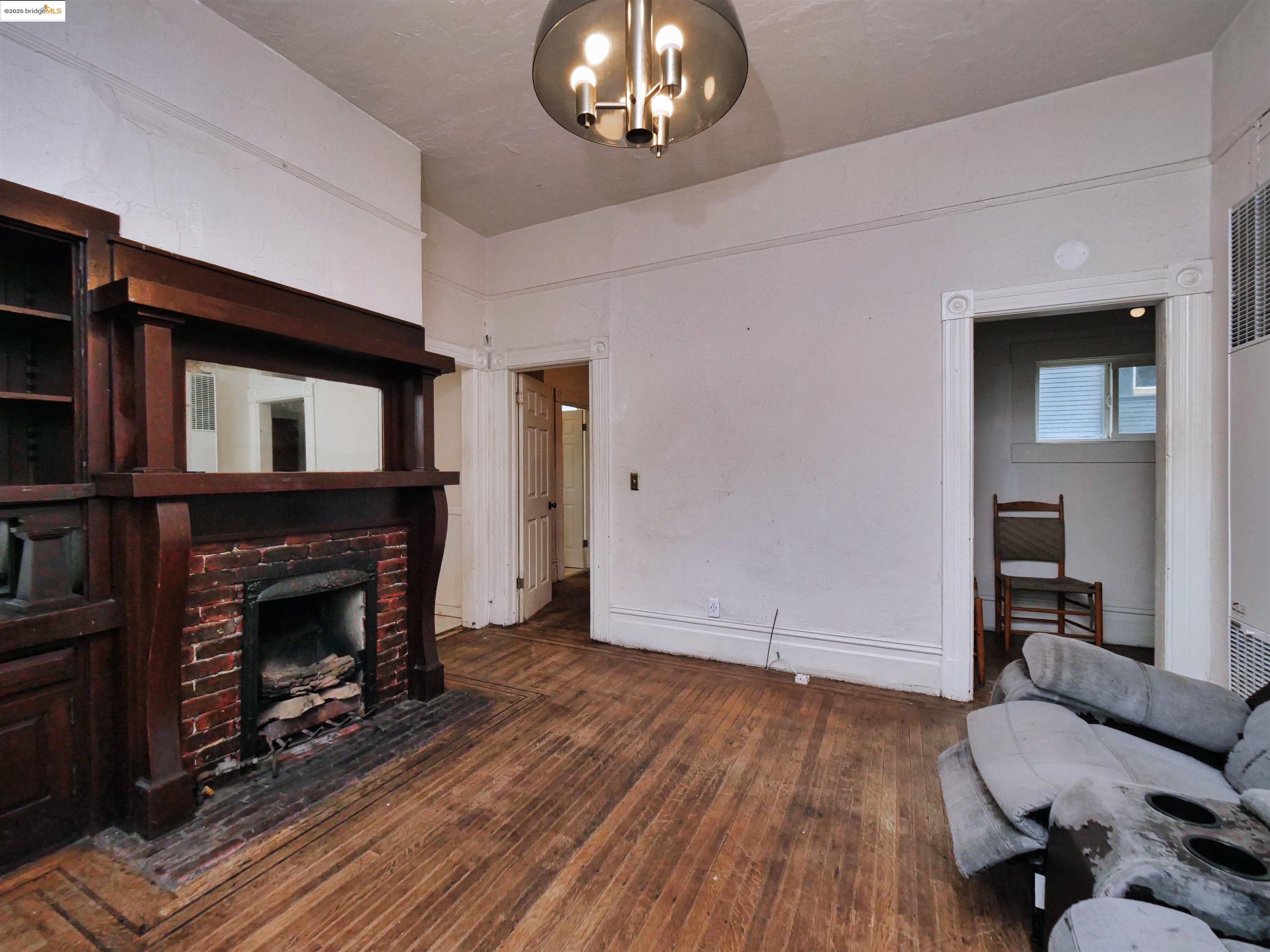 2103 Myrtle Street Oakland, CA 94607 - Photo 9 of 21 a view of livingroom with furniture wooden floor fireplace and a window