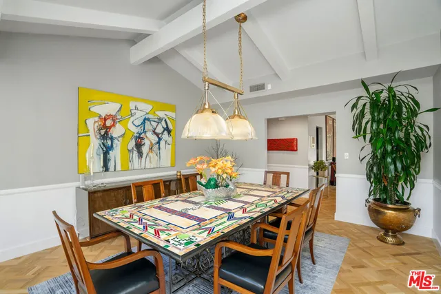 a dining room with fireplace furniture and a chandelier