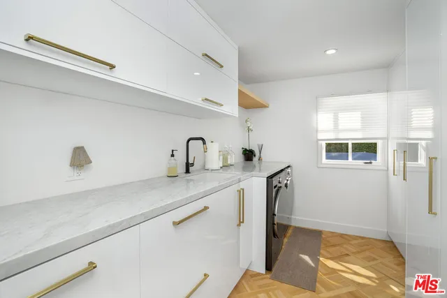 a living room with furniture a chandelier and a table