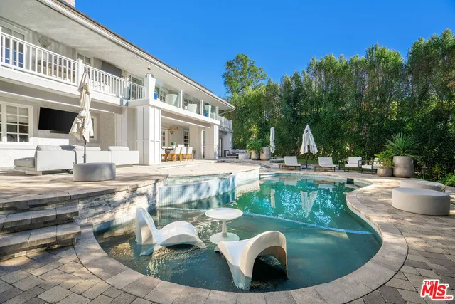 a backyard of a house with table and chairs