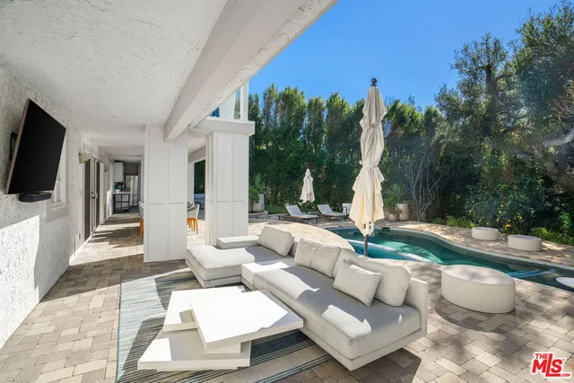 a view of a living room filled with furniture and a potted plant
