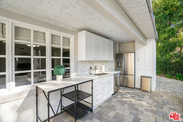 a swimming pool with trees in the background