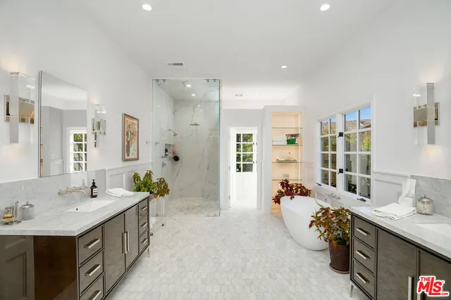 a bathroom with a tub sink and mirror