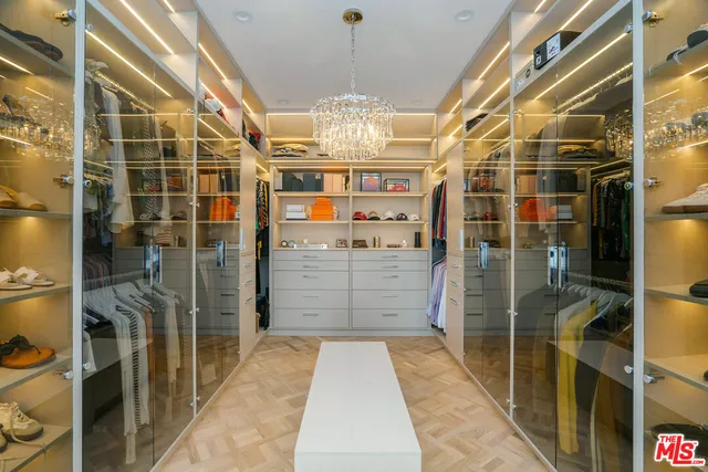 a kitchen with stainless steel appliances granite countertop a sink a stove and a dining table with wooden floor