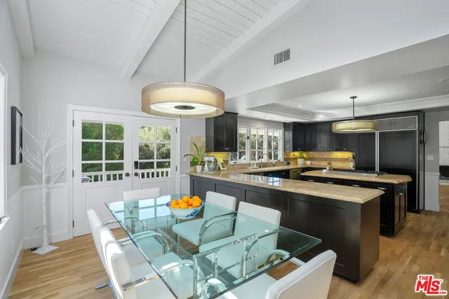 a view of a dining room with furniture a rug and wooden floor