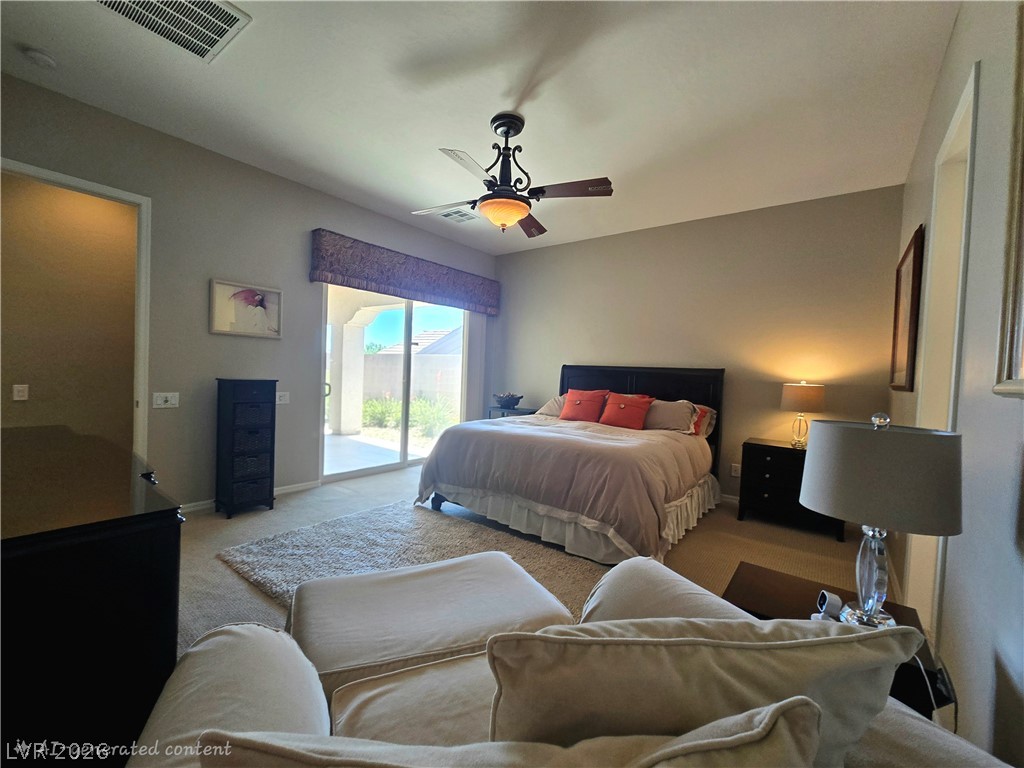 2567 Dirleton Place Henderson, NV 89044 - Photo 31 of 67 A spacious bedroom offers a tranquil retreat with direct access to the outdoors.