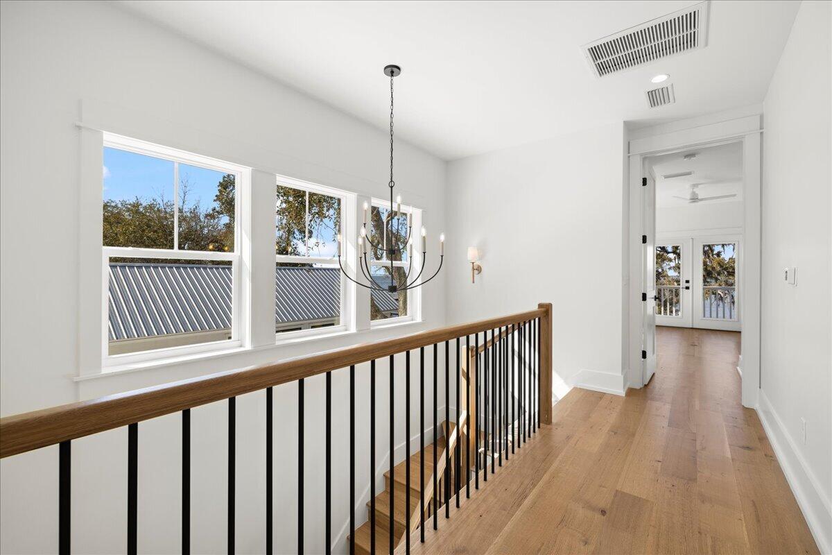 115 Native Tree Lane Santa Rosa Beach, FL 32459 - Photo 41 of 65 a view of a hallway with wooden floor and windows