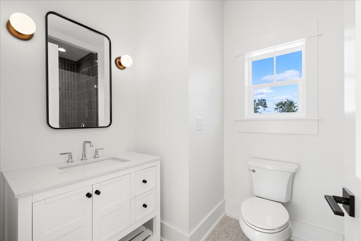 115 Native Tree Lane Santa Rosa Beach, FL 32459 - Photo 44 of 65 a bathroom with a toilet sink and mirror