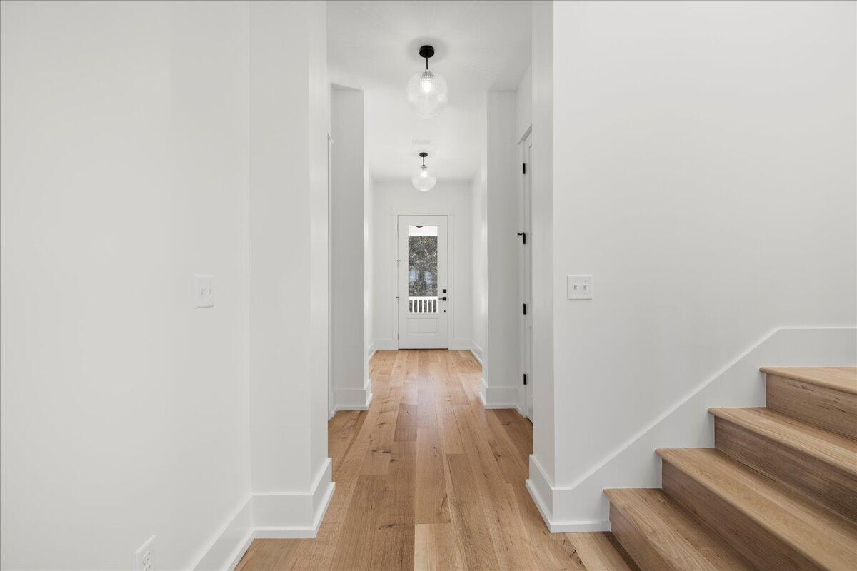 115 Native Tree Lane Santa Rosa Beach, FL 32459 - Photo 6 of 65 a view of a hallway with wooden floor and staircase