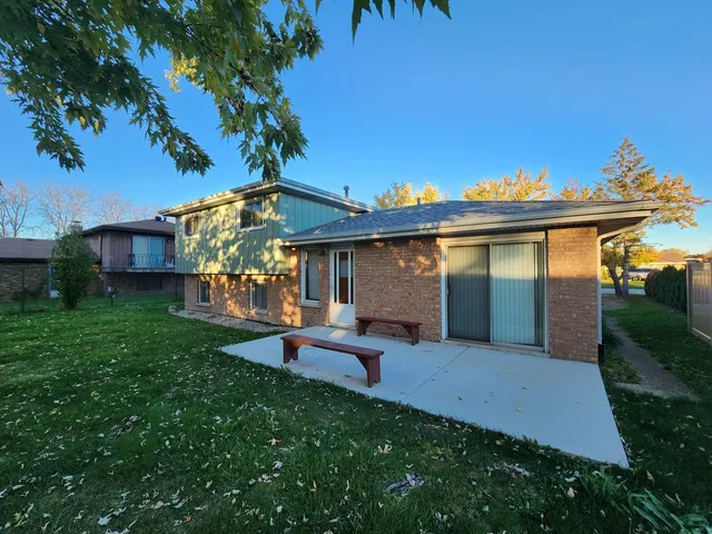 a view of a house with a yard porch and sitting area