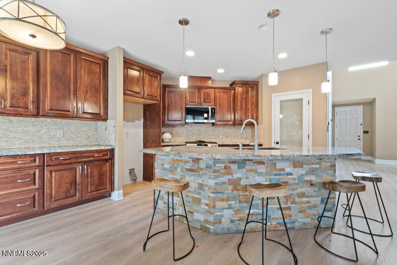 2968 Fox Trail Drive Reno, NV 89523 - Photo 5 of 24 a kitchen with stainless steel appliances granite countertop a stove a sink a refrigerator a center island with a dining table and chairs