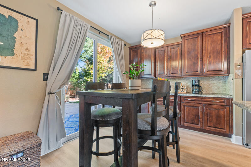 2968 Fox Trail Drive Reno, NV 89523 - Photo 6 of 24 a dining room with wooden floor a chandelier a wooden table and chairs