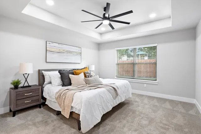 a bedroom with a bed a window and a chandelier