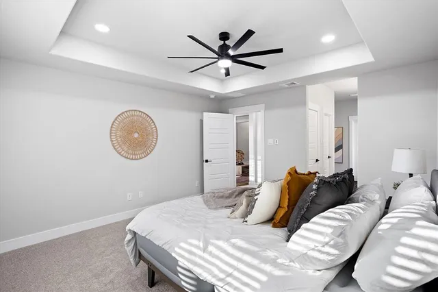 a bedroom with bed and a chandelier