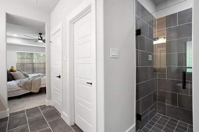 a bathroom with a glass door shower and a sink