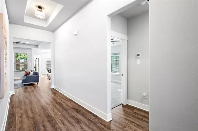 a view of a hallway view with wooden floor and a fireplace