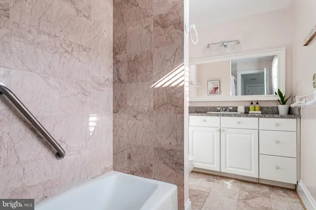 a bathroom with a bathtub and a sink