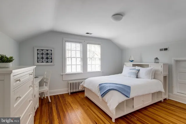 a bedroom with a bed and a dresser