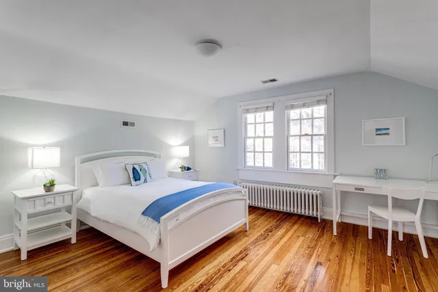 a bedroom with a bed and a table in it