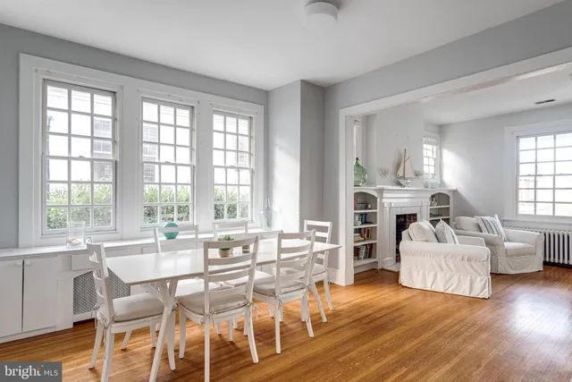 a living room with fireplace furniture and a large window