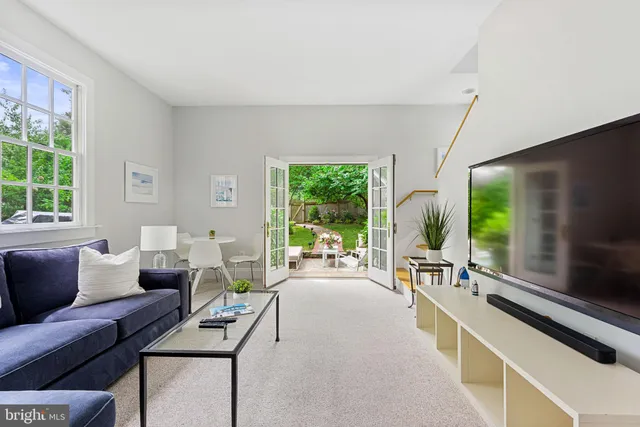 a living room with furniture tv and a large window
