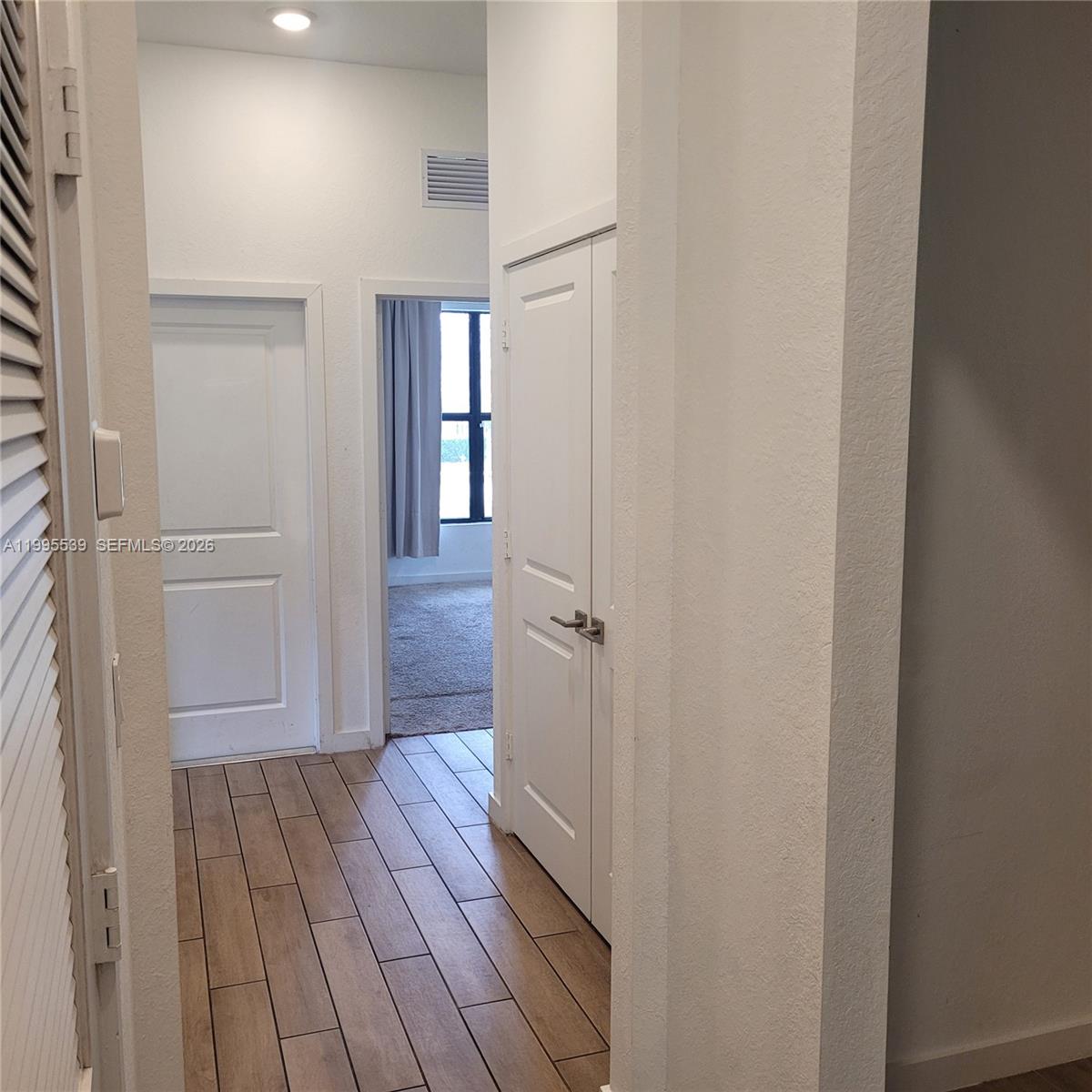 19723 Weathervane Way Loxahatchee, FL 33470 - Photo 19 of 24 a view of a hallway with wooden floor and staircase