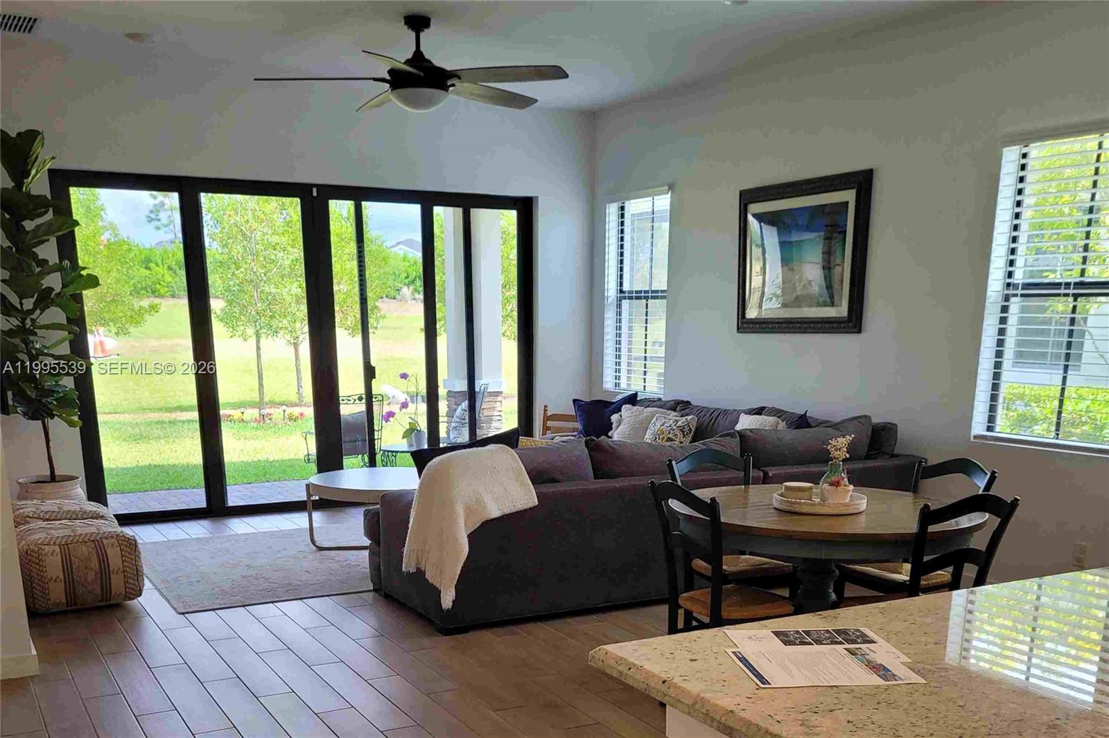 19723 Weathervane Way Loxahatchee, FL 33470 - Photo 2 of 24 a living room with furniture and a floor to ceiling window