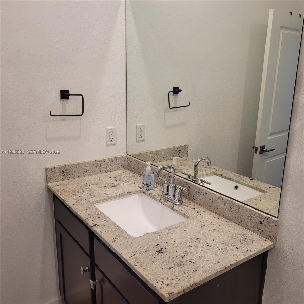 19723 Weathervane Way Loxahatchee, FL 33470 - Photo 21 of 24 a bathroom with a granite countertop sink and a mirror