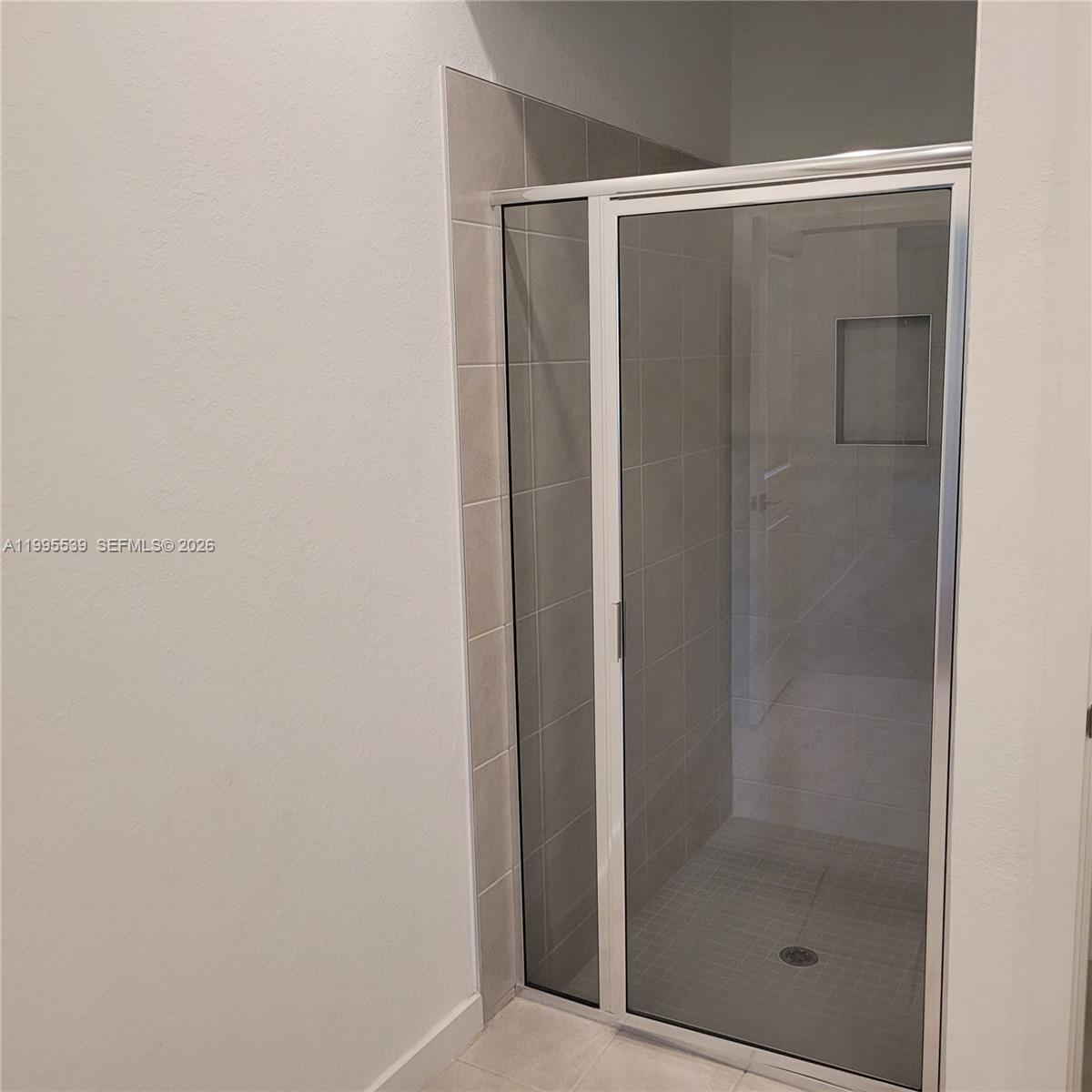 19723 Weathervane Way Loxahatchee, FL 33470 - Photo 24 of 24 a bathroom with a glass shower door