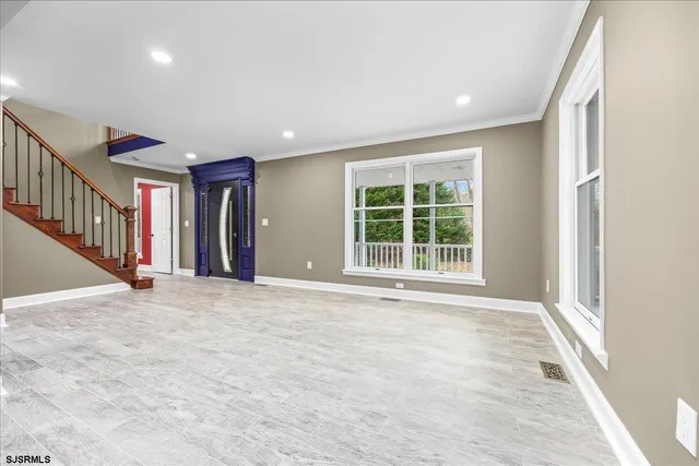 an empty room with wooden floor and fireplace